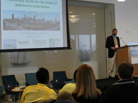 Dr. Heath Kelsey discussing the health of Baltimore's Harbor at the "State of the Harbor" conference.
