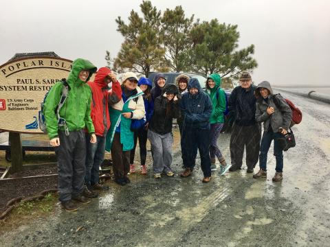 The biological oceanography class poses at the end of its tour of Poplar Island.