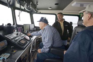 Captain Michael Reusing piloting the R/V Rachel Carson as Governor Martin O’Malley and UMCES Research Fleet Superintendent Bruce Cornwall look on (May 11, 2009).
