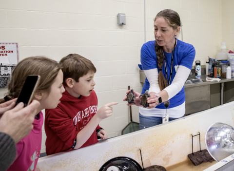 Kids attending the CBL centennial celebration tour the terrapin  nursery.